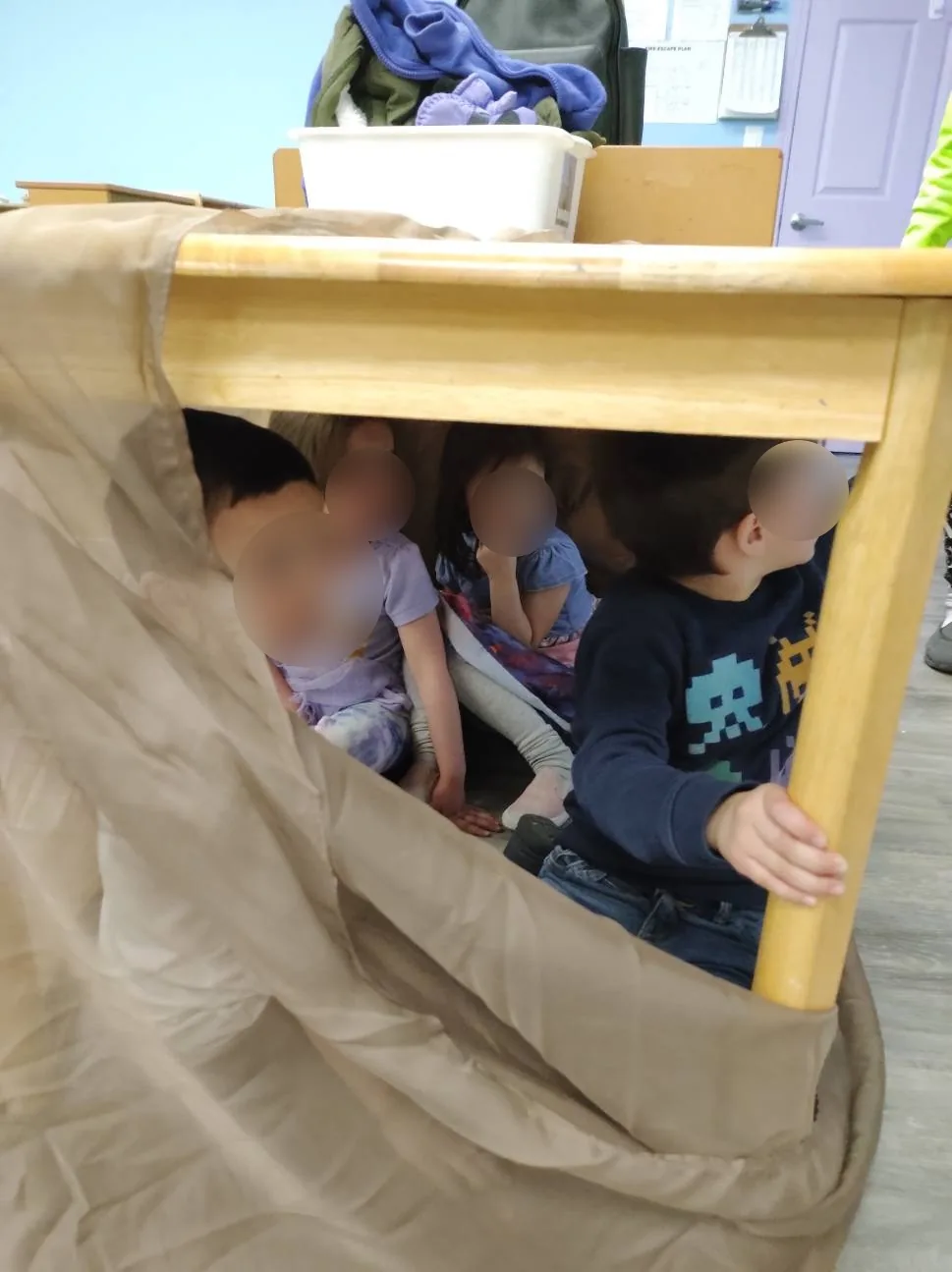 Village Scholars Preschool photo: hiding, peeking, and social play