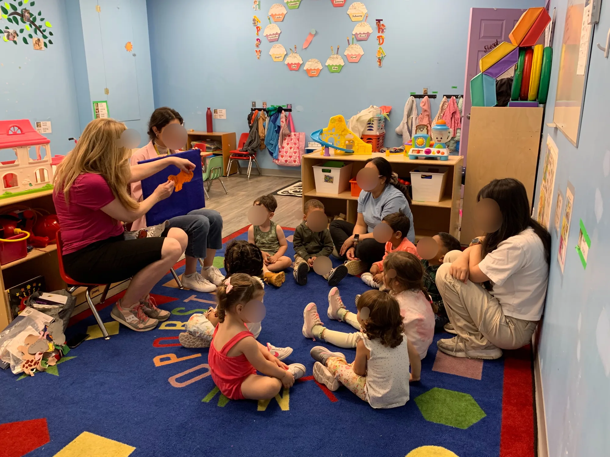 Educators and children during group time at Village Scholars Preschool