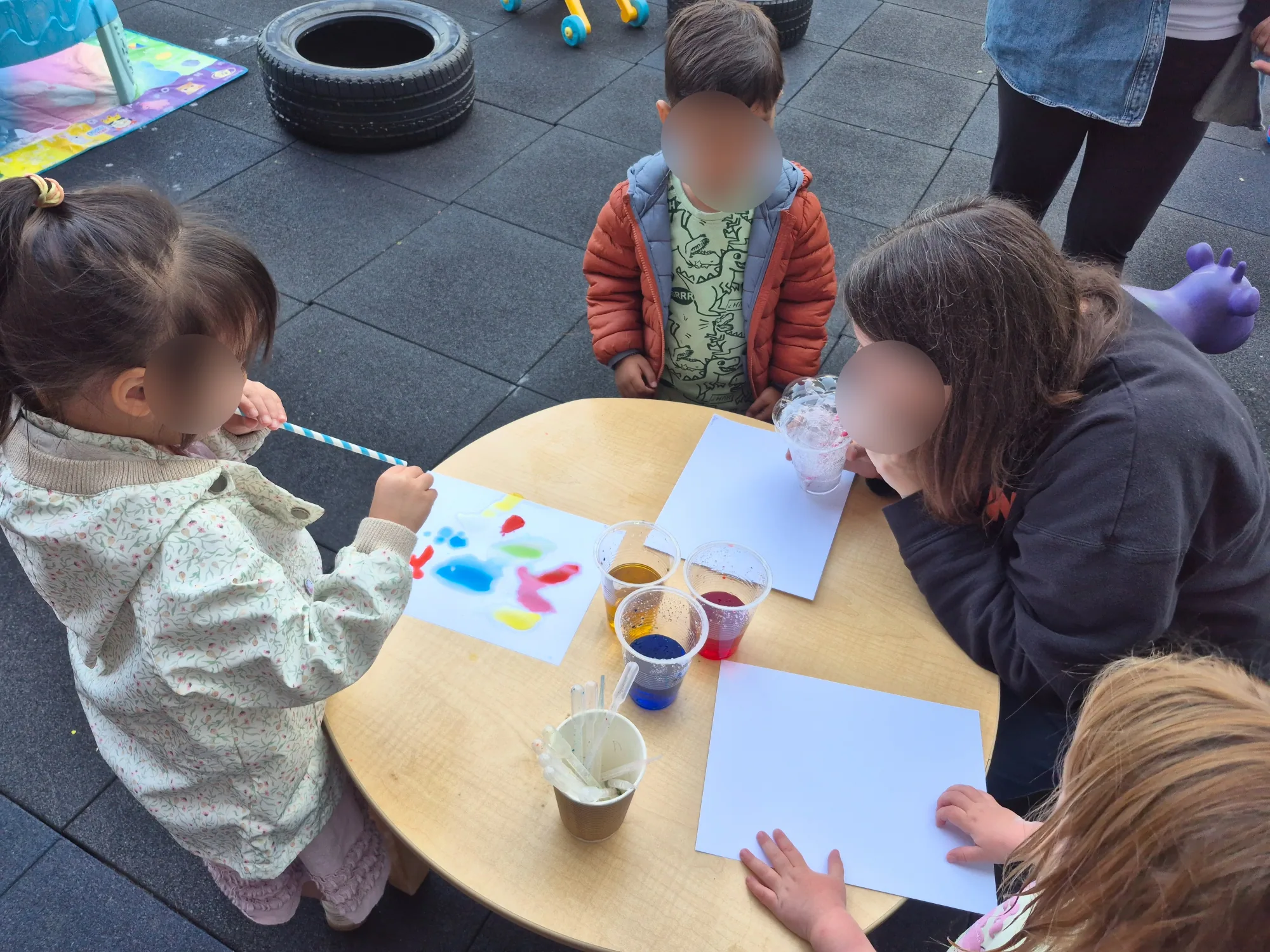 Village Scholars Preschool photo: painting with careful hands and bright colours