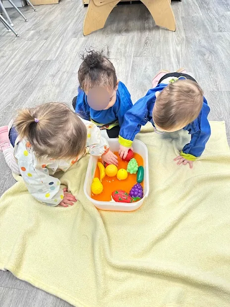 Village Scholars Preschool photo: sorting bright balls and small containers