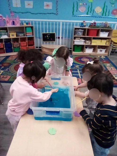 Village Scholars Preschool photo: blue water play with cups and scoops