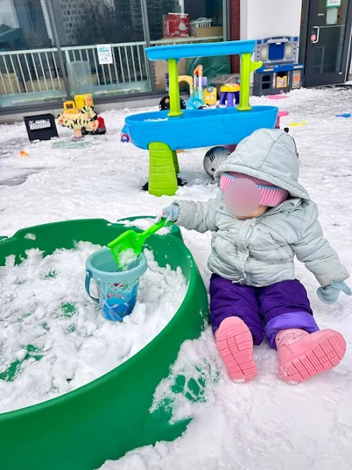 Village Scholars Preschool photo: scooping snow and experimenting outdoors